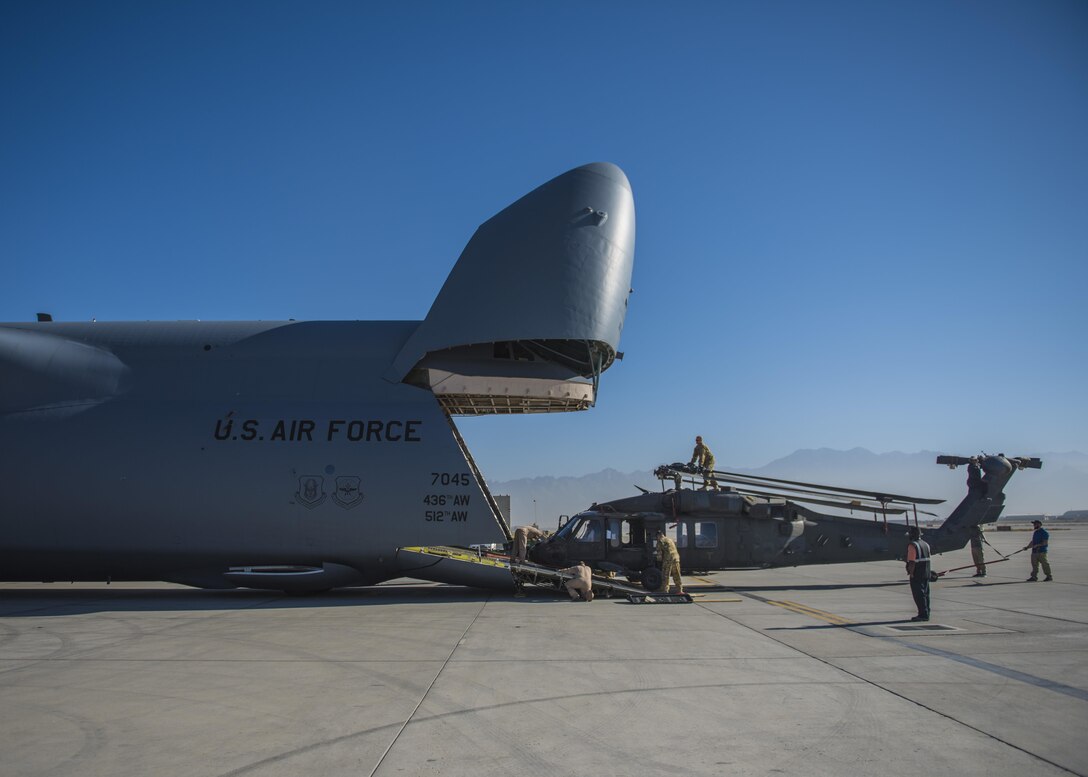 A Sikorsky UH-60 Blackhawk is hauled into a C-5 Galaxy for transport, Bagram Airfield, Afghanistan, Sept. 8, 2016. When Army aircrew units redeploy back to their home stations, the Blackhawks are packed up and transported back on aircraft such as the C-5 Galaxy. As the Air Force’s largest strategic airlifter, the C-5 can handle a payload of up to 5 helicopters. (U.S. Air Force photo by Senior Airman Justyn M. Freeman)