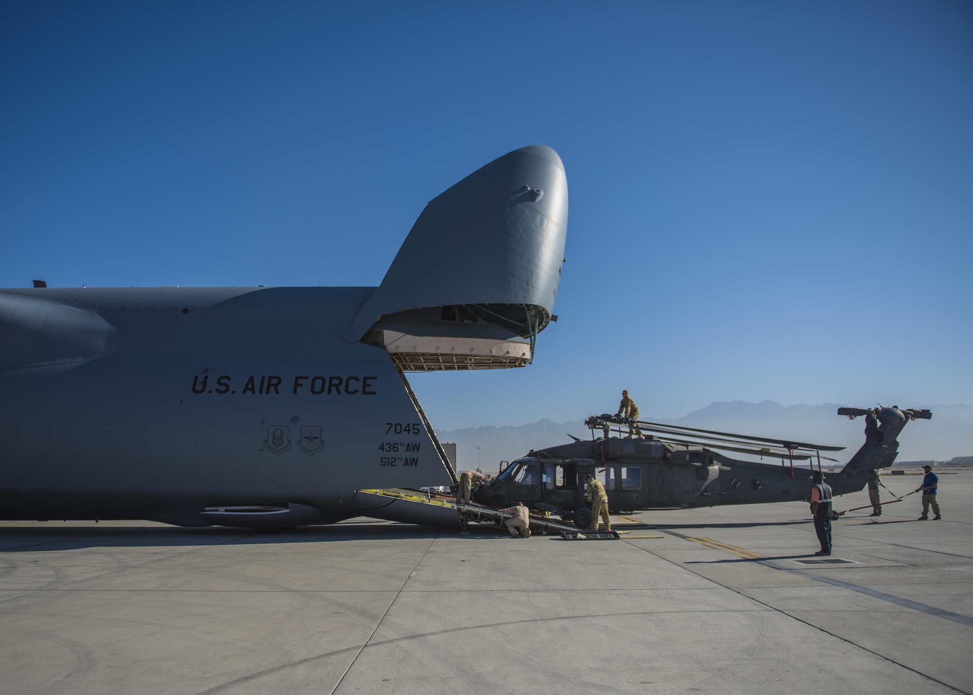A Sikorsky UH-60 Blackhawk is hauled into a C-5 Galaxy for transport, Bagram Airfield, Afghanistan, Sept. 8, 2016. When Army aircrew units redeploy back to their home stations, the Blackhawks are packed up and transported back on aircraft such as the C-5 Galaxy. As the Air Force’s largest strategic airlifter, the C-5 can handle a payload of up to 5 helicopters. (U.S. Air Force photo by Senior Airman Justyn M. Freeman)