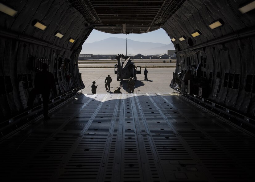 A Sikorsky UH-60 Blackhawk is guided into a C-5 Galaxy for transport, Bagram Airfield, Afghanistan, Sept. 8, 2016. When Army aircrew units redeploy back to their home stations, the Blackhawks are packed up and transported back on aircraft such as the C-5 Galaxy. As the Air Force’s largest strategic airlifter, the C-5 can handle a payload of up to 5 helicopters. (U.S. Air Force photo by Senior Airman Justyn M. Freeman)