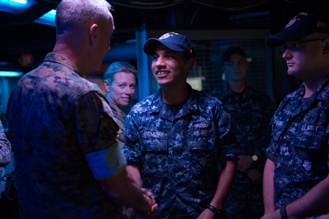 Marine Corps Gen. Joe Dunford, chairman of the Joint Chiefs of Staff, speaks with Navy Petty Officer 2nd Class Christopher Arizmendi, a fire controlman, while visiting the Arleigh Burke-class guided missile destroyer USS Barry in Yokosuka, Japan, Sept. 7, 2016. DoD photo by Army Sgt. James K. McCann
