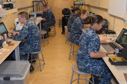 Sailors from Southeast Regional Maintenance Center (SERMC) experiment with the different gear delivered from Defense Advanced Research Projects Agency (DARPA). The Fab Lab is a design and fabrication shop and is strictly for experimental use by SERMC Sailors.