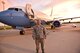 Tech. Sgt. Joseph Reinhold stands before a 932nd Airlift Wing C-40C that he helps to maintain, as the sun sets in Illinois.  He assisted with setting up the static display for the recent Belle-Scott after hours orientation event, showing off the mission and people of the Illinois Air Force Reserve unit.  (U.S. Air Force photo by Christopher Parr)