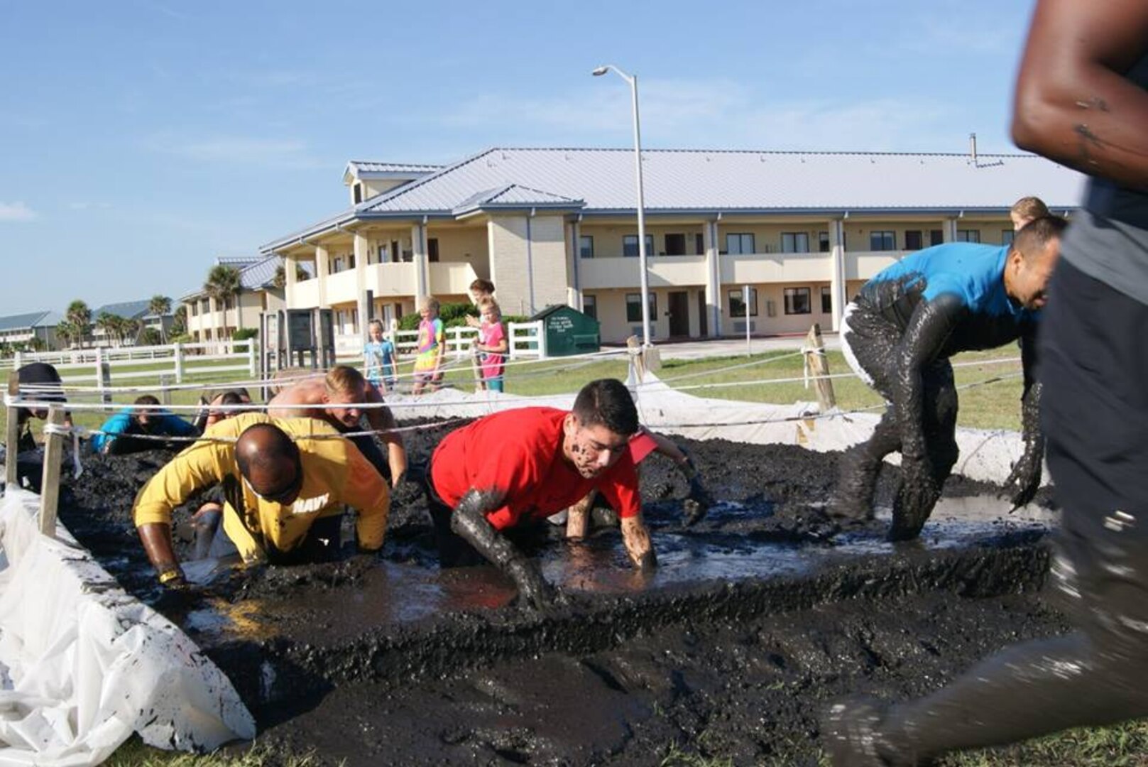 Runners race through obstacles during the Morale, Welfare and Recreation (MWR) Mayport Mud Run 2016. The event is an annual fitness challenge hosted by MWR for service members and their families to promote health and well-being.