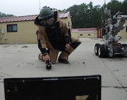 Senior Airman Brayden Kerr, 2nd Civil Engineer Squadron Explosive Ordnance Disposal Flight team member, uses the operating control unit to pilot the F6A robot at Barksdale Air Force Base, La., Sept. 6, 2016. The OCU controls the robot’s movements and camera, allowing the technicians to safely eliminate threats from a distance. (U.S. Air Force photo/Airman 1st Class Stuart Bright)