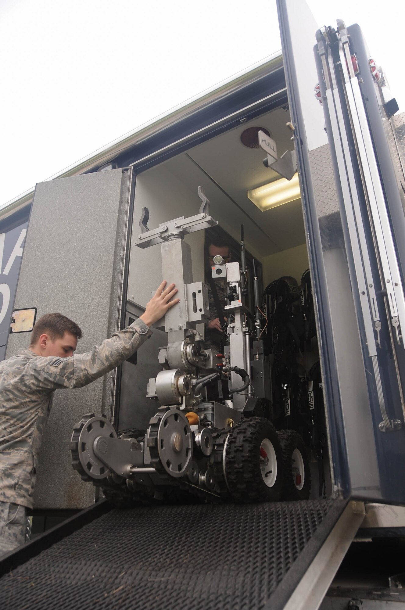 Senior Airman Brayden Kerr, 2nd Civil Engineer Squadron Explosive Ordnance Disposal Flight team member, uses the operating control unit to pilot the F6A robot at Barksdale Air Force Base, La., Sept. 6, 2016. The OCU controls the robot’s movements and camera, allowing the technicians to safely eliminate threats from a distance. (U.S. Air Force photo/Airman 1st Class Stuart Bright)