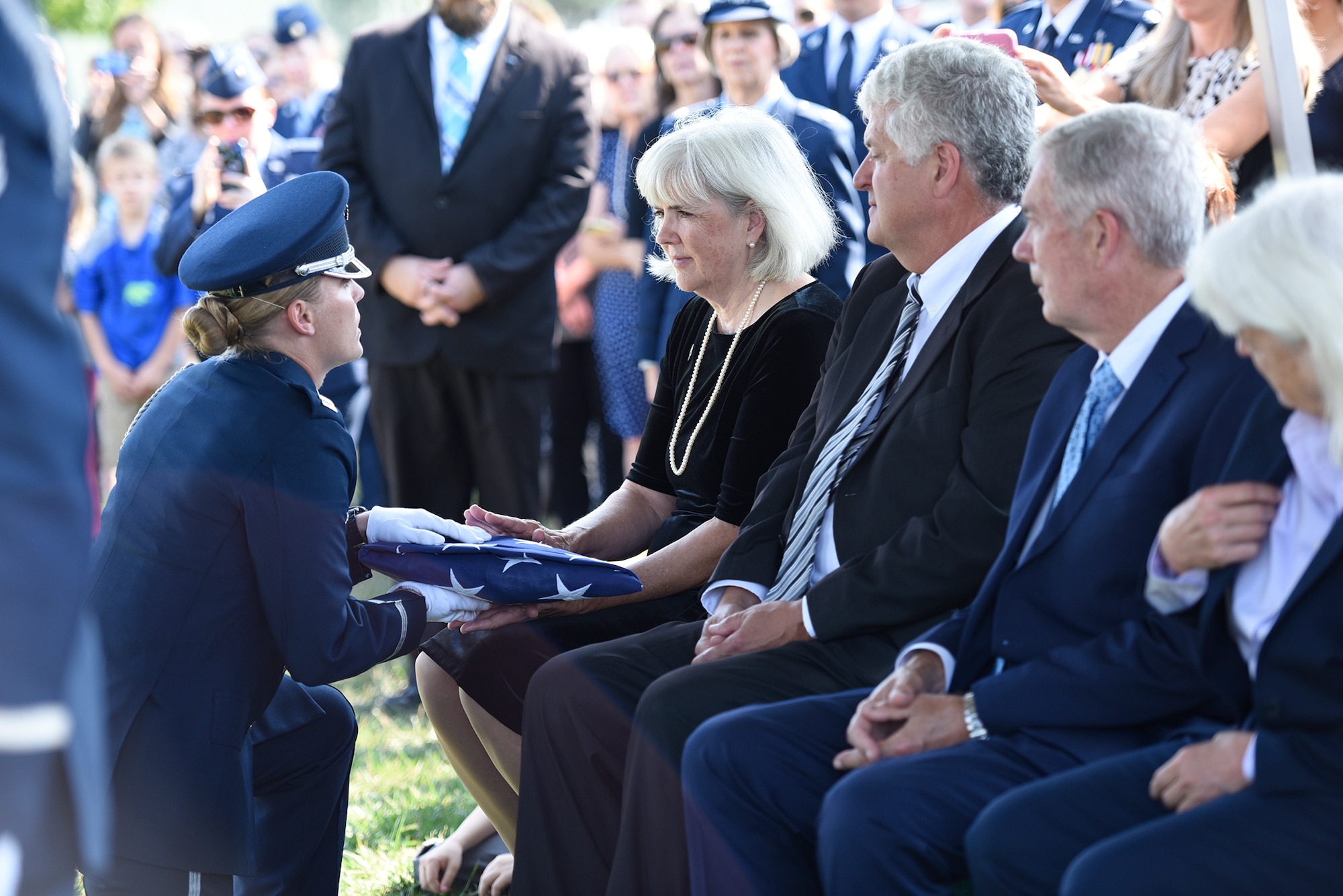 Terry Harmon, the daughter of Women Airforce Service Pilot 2nd Lt. Elaine Harmon, receives the American flag from a member of the U.S. Air Force Honor Guard during her late-mother’s interment ceremony at Alrington National Cemetery, Va., Sept. 7, 2016. Harmon died in 2015 at the age of 95. (U.S. Air Force photo/Staff Sgt. Alyssa C. Gibson)