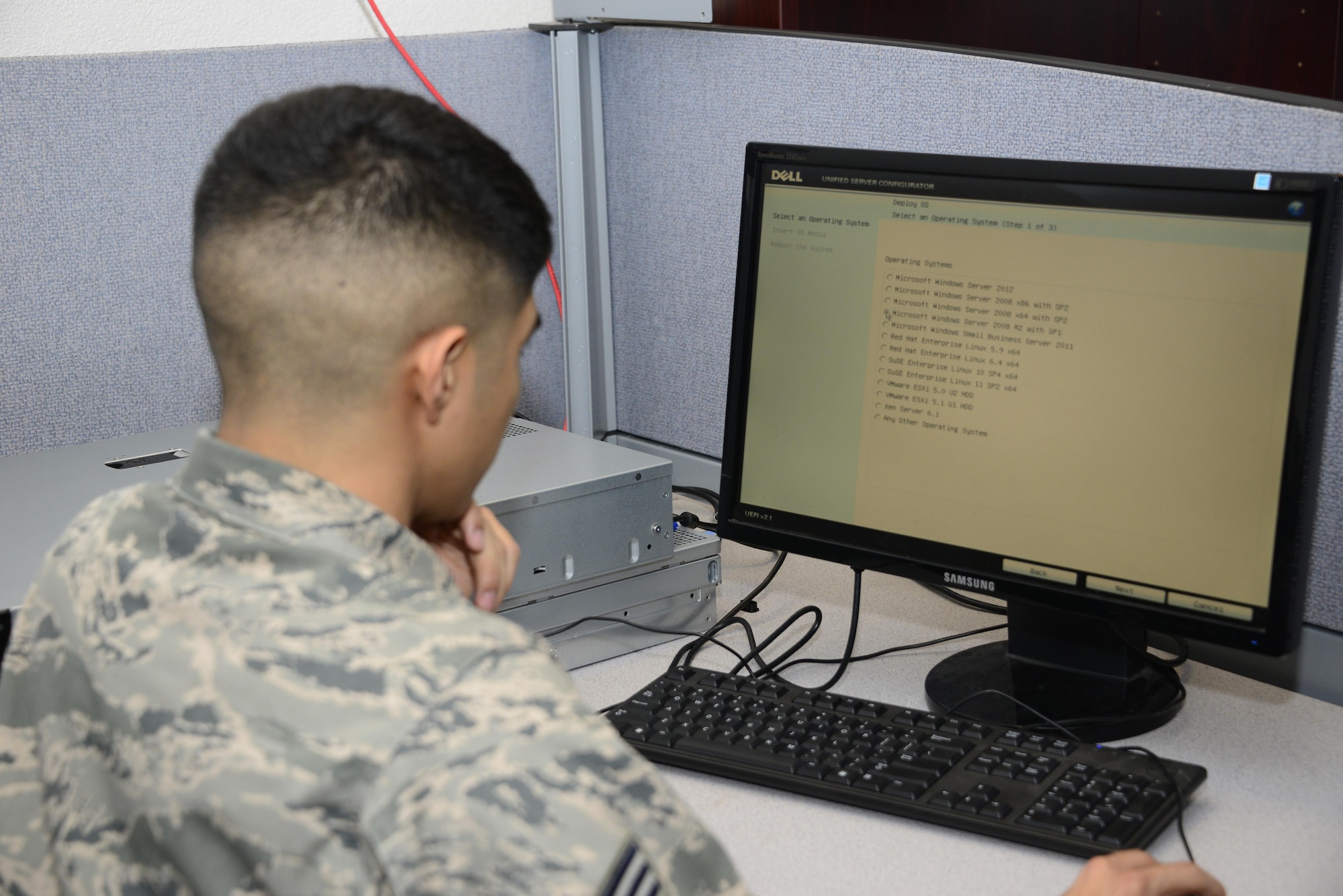 U.S. Air Force Senior Airman David Cruz, 355th Communications Squadron network operations technician, installs Windows Server 2008 on a print server at Davis-Monthan Air Force Base, Ariz., Sept. 7, 2016. The network operations team keeps base systems compliant with the standards of the Defense Information Systems Agency by using software, hardware and scripting solutions. (U.S. Air Force photo by Senior Airman Betty R. Chevalier)