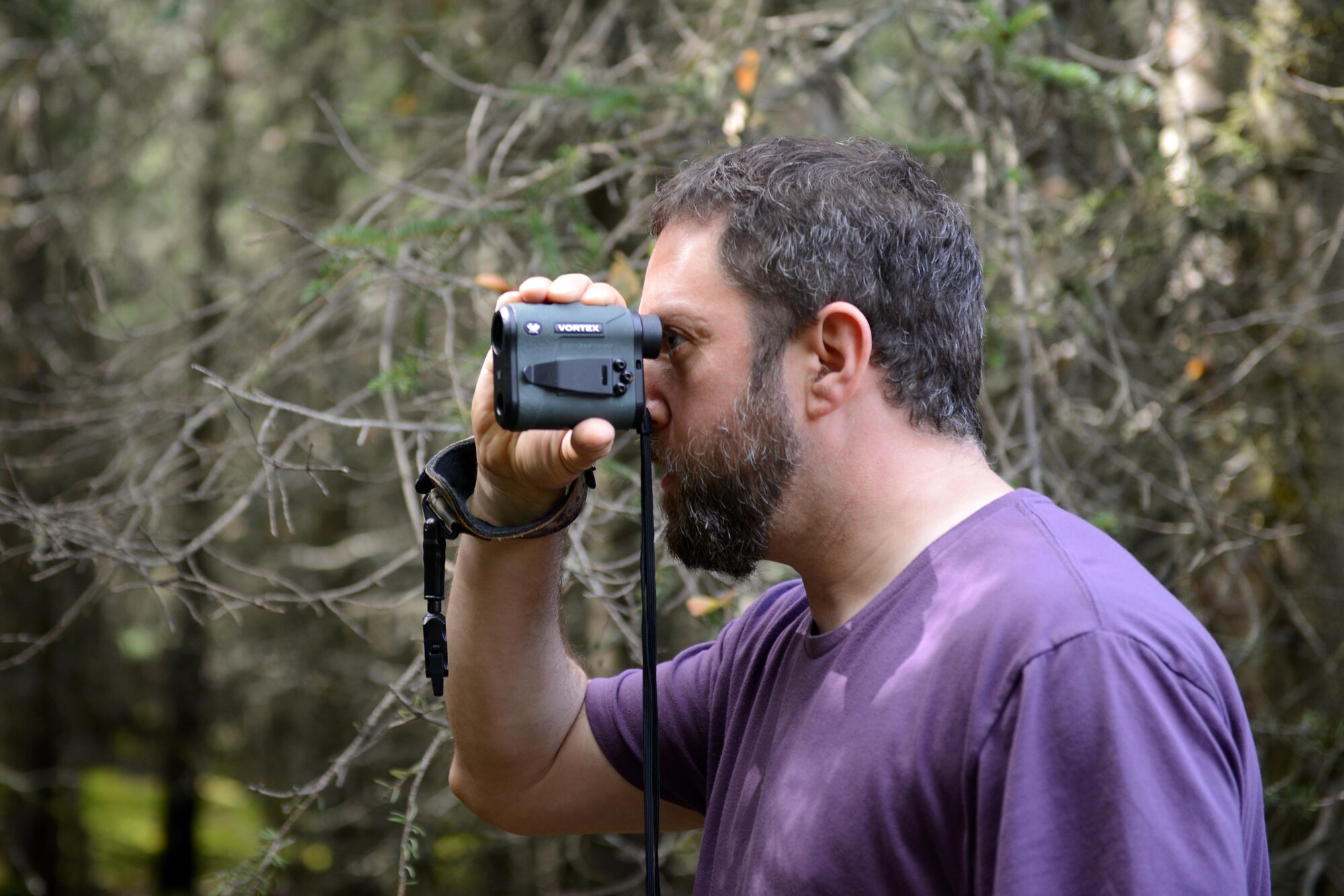 Marcus Knight, a GCI technician, looks through a rangefinder as part of a proficiency shoot for the Joint Base Elmendorf-Richardson moose hunt, at JBER, Alaska, Aug. 20, 2016. When a hunter releases a projectile on a hunt, whether or not contact is made, they have to contact the conservation law enforcement officers, said James Wendland, 673d Civil Engineer Squadron chief conservation law enforcement officer. 