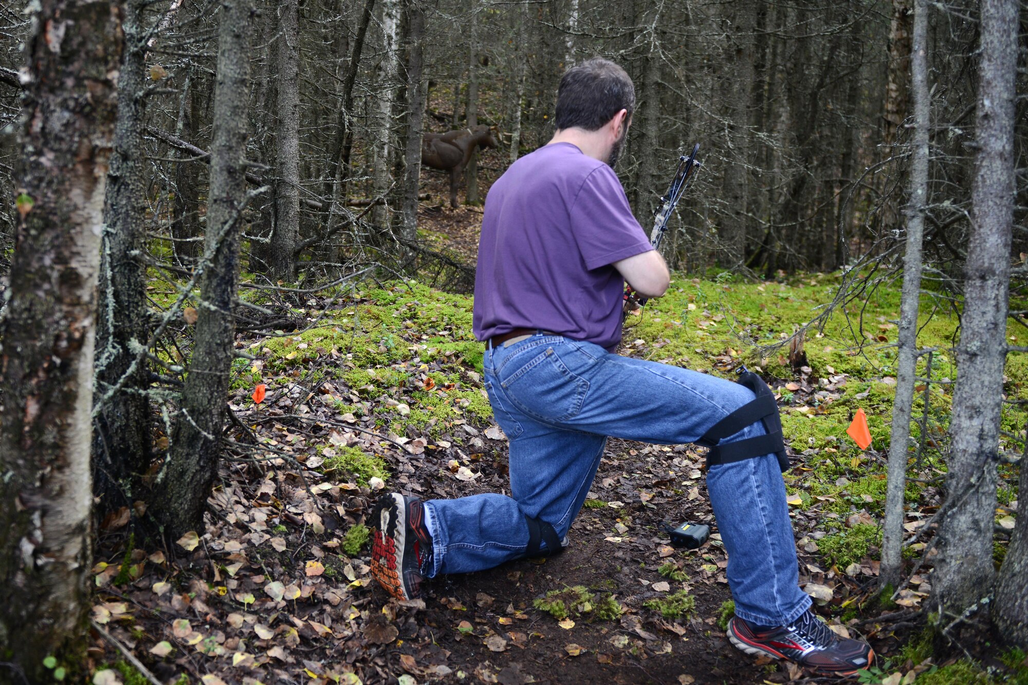Marcus Knight, a GCI technician, prepares to fire his bow as part of a proficiency shoot for the Joint Base Elmendorf-Richardson moose hunt, at JBER, Alaska, Aug. 20, 2016. On base, hunters must check in with the iSportsman system. 