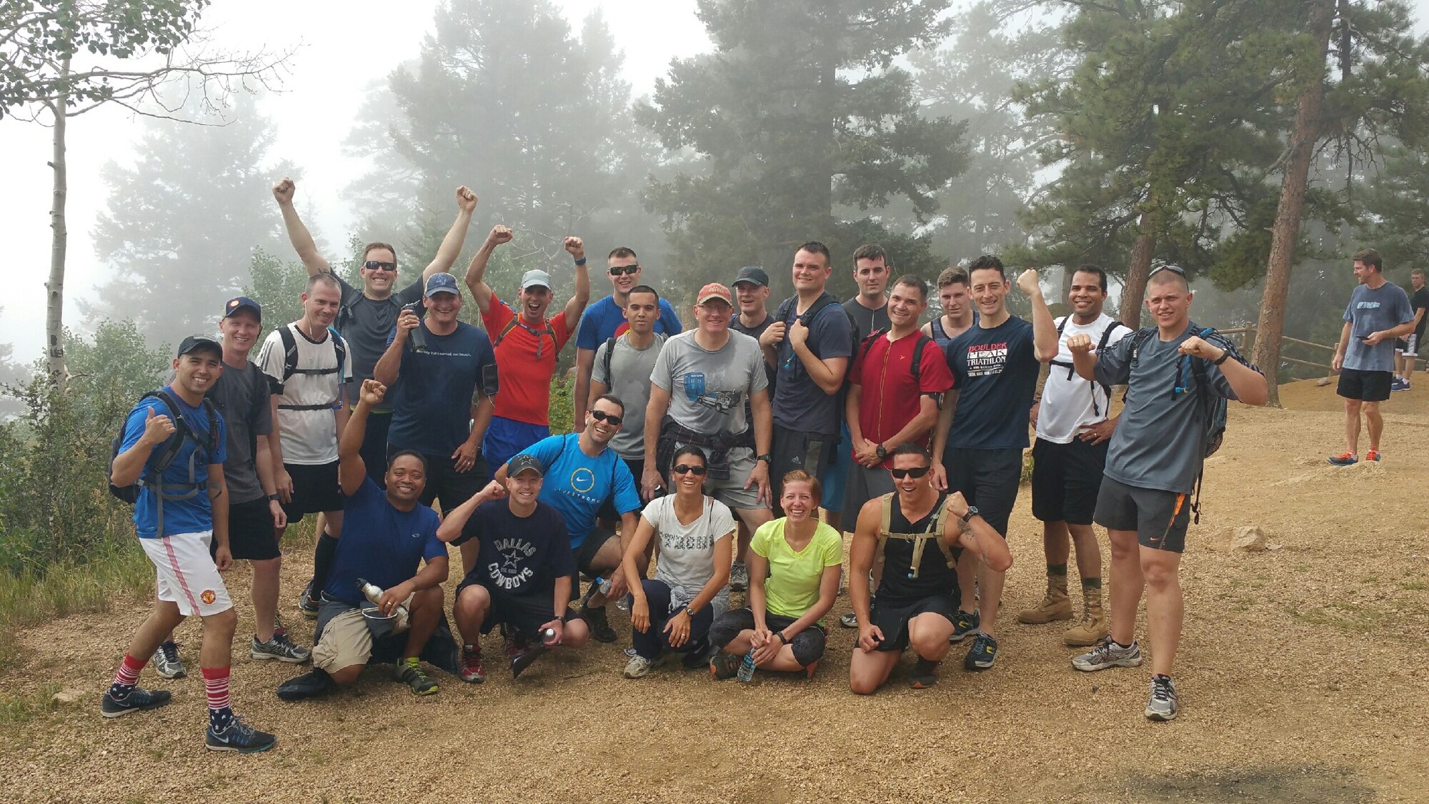 Citizen Airmen of the 960th Network Operations Squadron at Peterson Air Force Base, Colo., pose for a victory shot at the peak of Manitou Incline, a former railroad up the side of a mountain, in Colorado Springs. The railroad tracks have been removed, but the railroad ties remain and serve as the steps up the Incline, which number more than those of Empire State Building. The incline is just under one mile long, but climbs 2,000 vertical feet with an average steepness of 45 percent with some sections as steep as 68 percent. Climbers start at a base of 6,500 feet and end up at the peak at 8,590 feet. The Manitou Incline is considered one of the highest sets of stairs in the world. The outing was a morale and physical training event during the August unit training assembly.  (U.S. Air Force courtesy photo)
