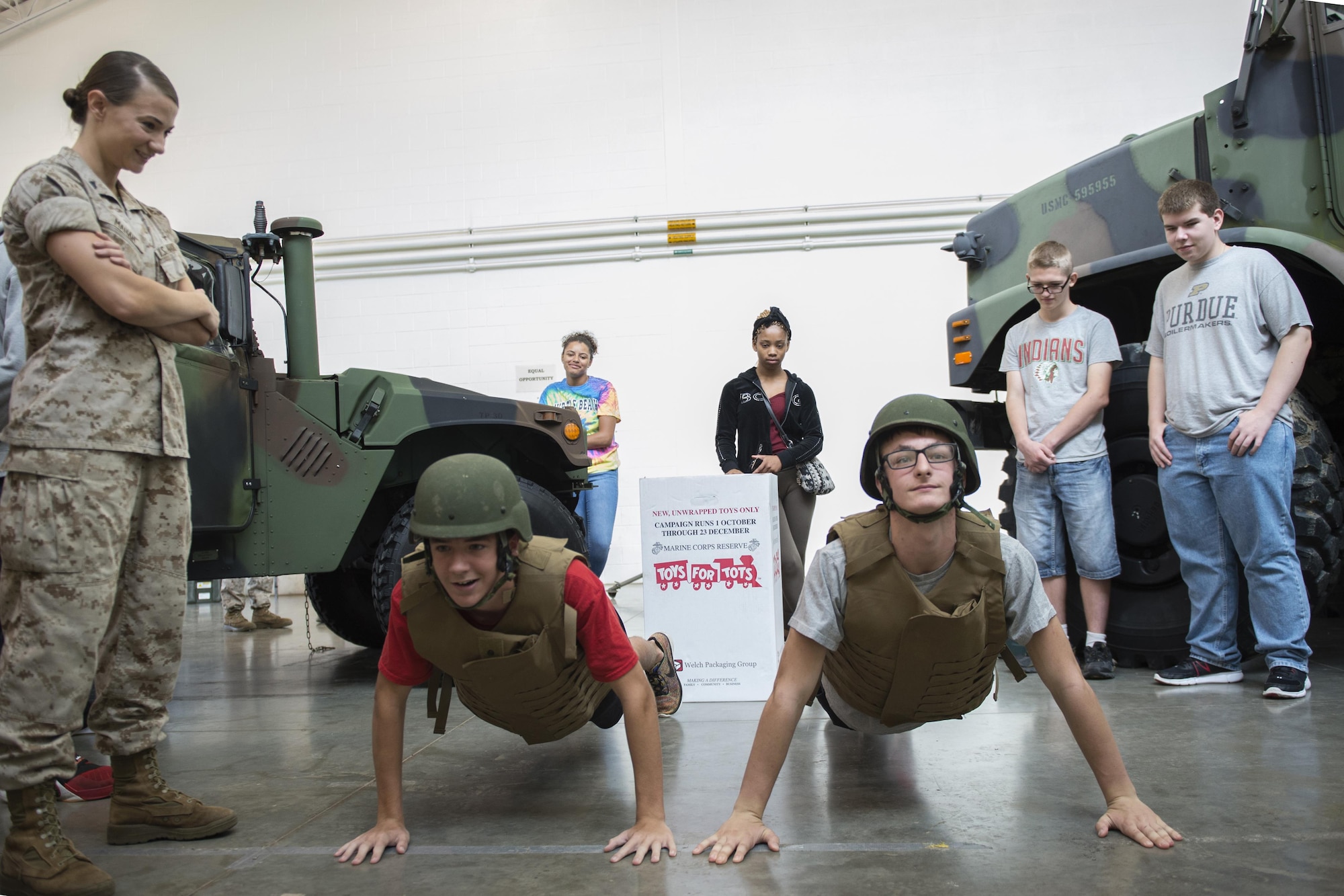 Steven Jacobs, left, and Matt Simpson, both Anderson High school Navy Junior ROTC cadets, complete a set of pushups during a tour at Grissom Air Reserve Base, Ind., Aug. 24, 2016. The tour was designed to give cadets a look at career fields from different military services to help cadets determine what they want to do after graduating high school. (U.S. Air Force photo/Tech. Sgt. Benjamin Mota)