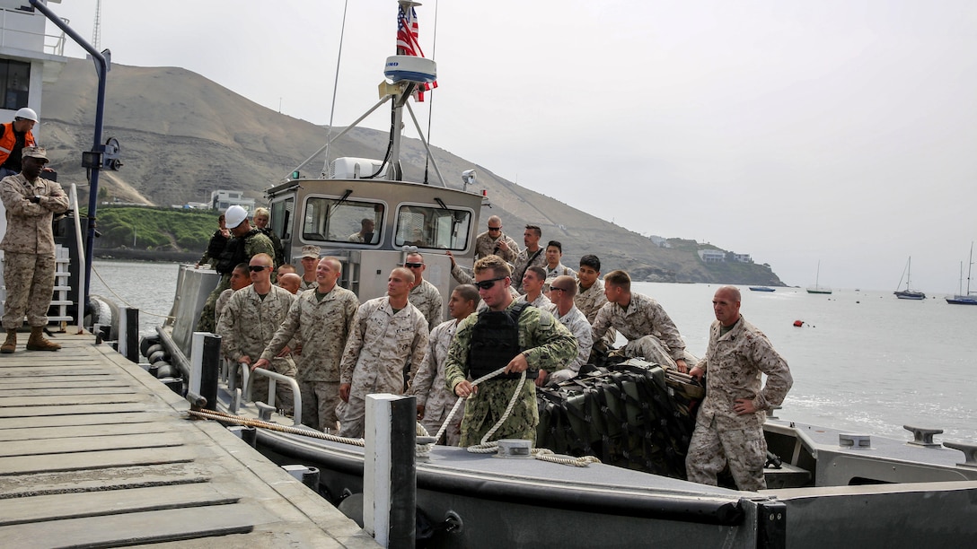 U.S. Marines with Task Force Koa Moana wait for their boat to be secured before disembarking after arriving in Ancon, Peru, Sept. 2, 2016. Task Force Koa Moana is in Peru as part of a theater security cooperation engagement to integrate and improve interoperability with Peruvian Marines. Together with the USNS Pililaau, the Marines and sailors of the task force highlighted the strength and capabilities of the Navy-Marine Corps team.