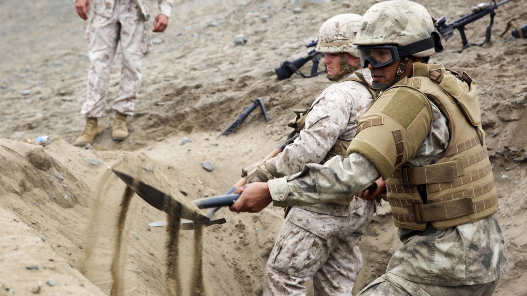 A Peruvian Marine works together with U.S. Marines and sailors from Task Force Koa Moana to fill sandbags during a class on constructing fighting positions in Ancon, Peru, Sept. 3, 2016. Force Koa Moana is in Peru as part of a theater security cooperation engagement to integrate and improve interoperability with Peruvian Marines. The training blurs the traditional boundaries between U.S. combatant commands due to coordination between U.S. Marine Corps Forces, Pacific and U.S. Marine Corps Forces, South. The task force is also scheduled to conduct training events in other Pacific countries like Vanuatu, Fiji and Timor Leste. (U.S. Marine Corps photo by. Sgt. Jacob Smith)