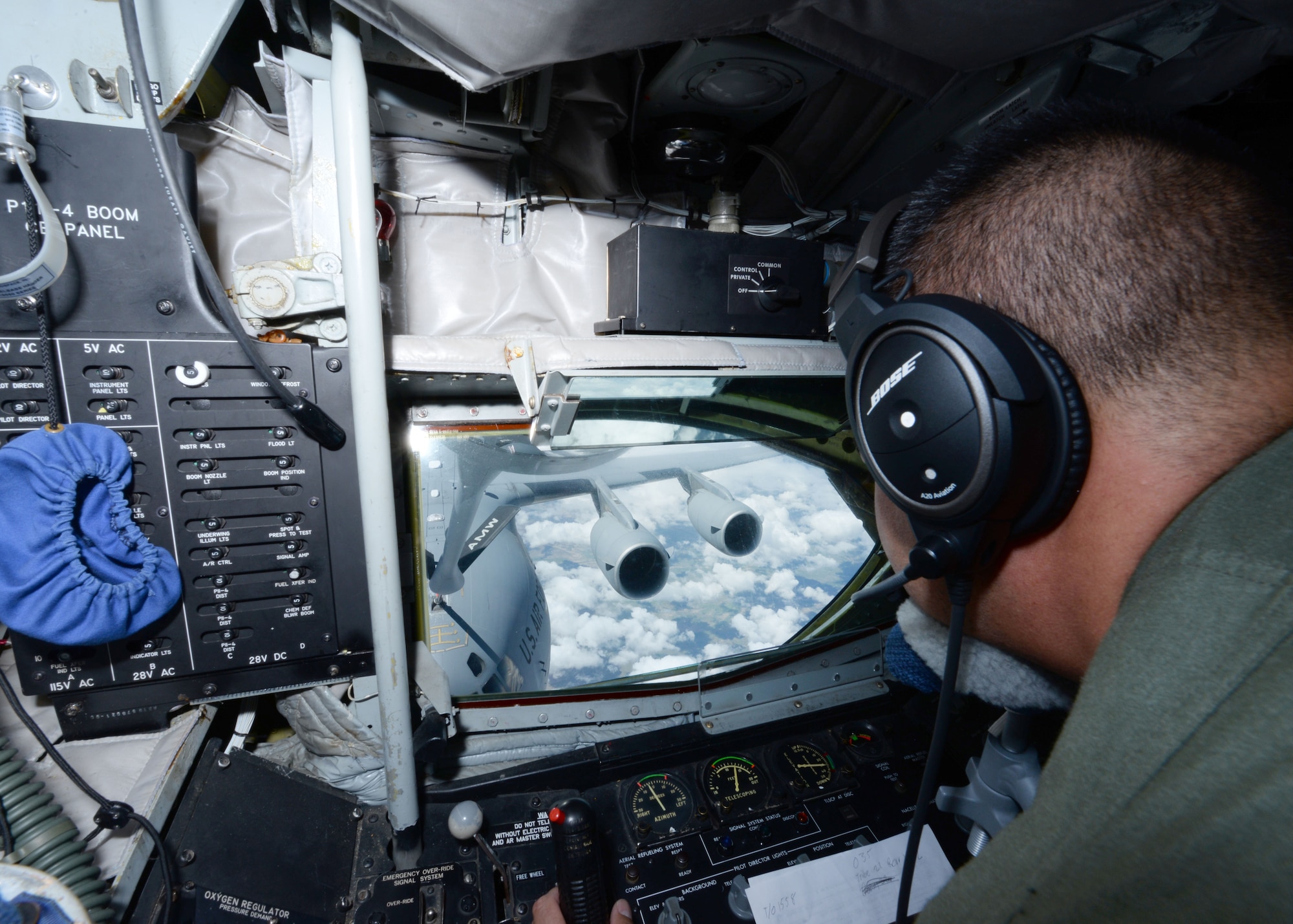 U.S. Air Force Master Sgt. Rob Miller, 97th Training Squadron evaluator boom operator, operates the boom to fuel a nearby C-17 Globemaster III over Texas, Aug. 31, 2016.This was the 60th anniversary flight of the KC-135 that has provided long-range aerial refueling support for Air Force, Navy, Marine Corps and allied aircraft for years.