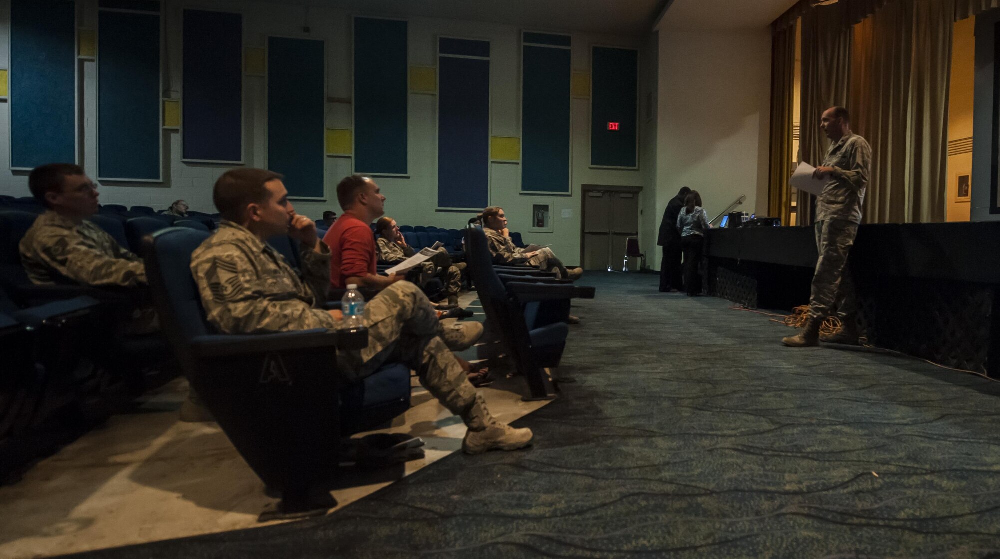 Lt. Col. Mike Freeman, 99 Civil Engineering Squadron Commander, explains the changes made to utility allowance to Airmen that attended a town hall meeting at the Nellis Base Theater, Aug. 30, 2016. Freeman then outlined how the old system and the new system will be different for the residents of base housing and how the new system will serve multiple purposes. (U.S. Air Force photo by Airman 1st Class Kevin Tanenbaum/Released)