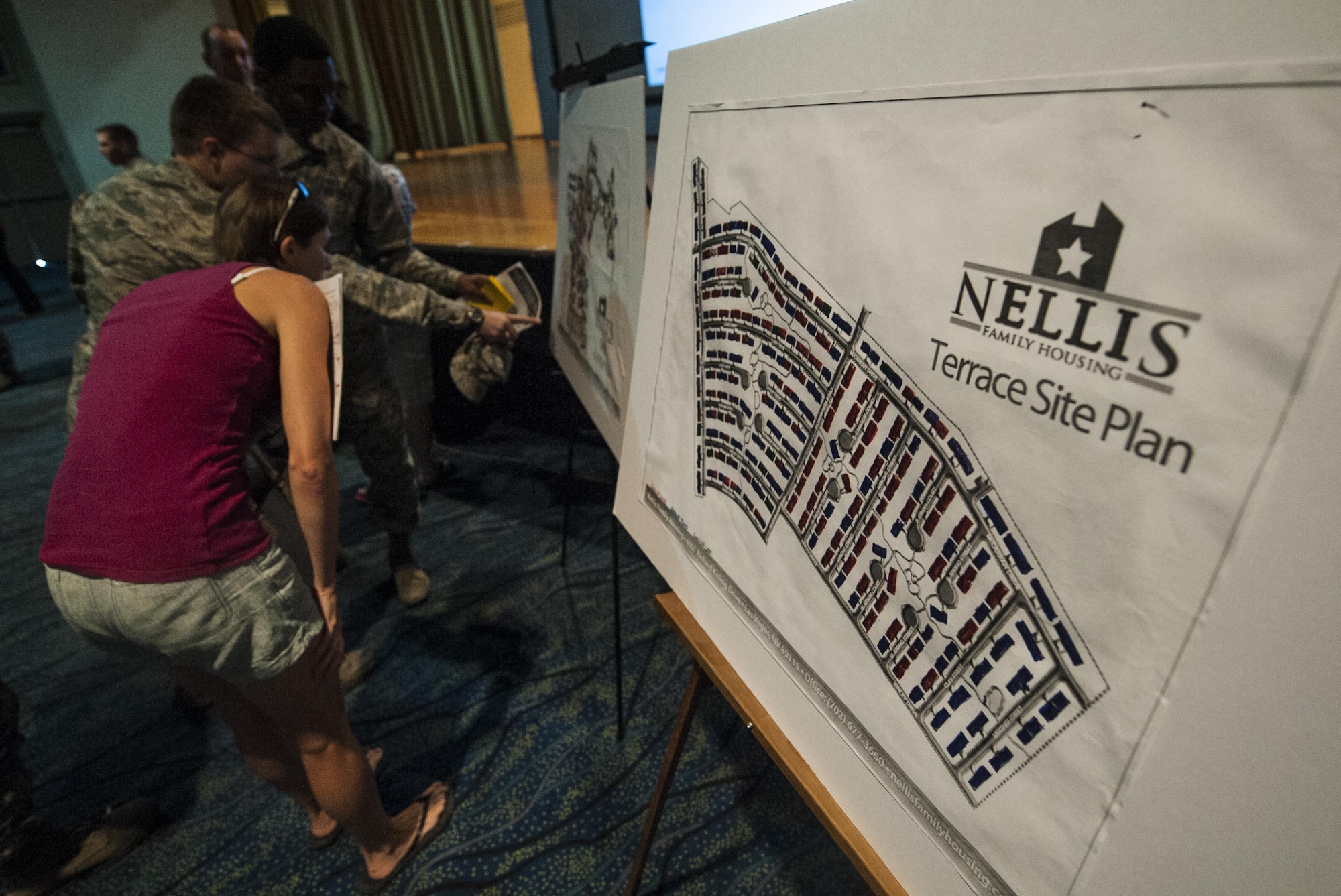 Airmen and spouses that attended a town hall meeting discussing the changes in utility allowance view a map of base housing at the Nellis Base Theater, Aug. 30, 2016. Col. Zev York, 99th Air Base Wing Vice Commander, and Lt. Col. Mike Freeman, 99th Civil Engineering Squadron Commander took time to explain in detail the changes will be occurring to base resident’s utility allowance. (U.S. Air Force photo By Airman 1st Class Kevin Tanenbaum/Released) 