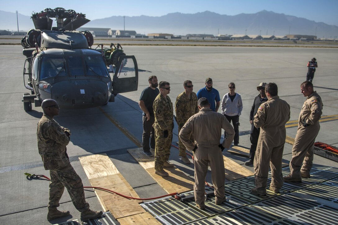 Senior Airman Maxwell Lucchesi, center right, gives a mission and safety brief to service members and civilians on the flightline at Bagram Airfield, Afghanistan, Sept. 8, 2016. Lucchesi is an aircraft loadmaster assigned to the 436th Airlift Wing, deployed from Dover Air Force Base, Del. Air Force photo by Senior Airman Justyn M. Freeman