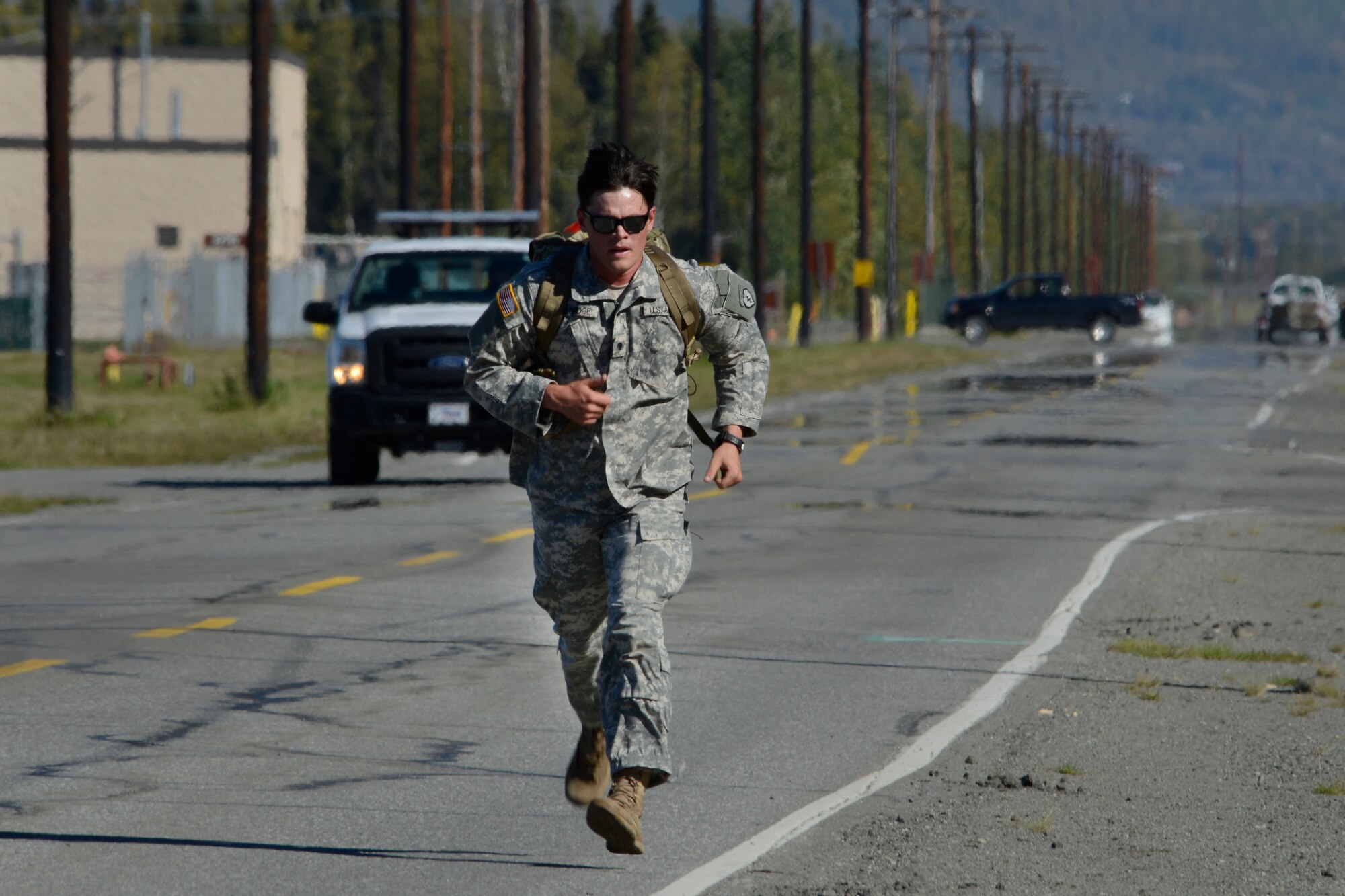 Spc. Andrew Eldridge, assigned to the 1st Battalion, 501st Parachute Infantry Regiment, 4th Infantry Brigade Combat Team (Airborne), 25th Infantry Division, U.S. Army Alaska, competes in the Combat Cross-Country Series 10-Mile Relay on the Davis Highway, Sept. 1, 2016. The relay consisted of five-man teams in Army Combat Uniforms and combat boots racing for the best time with 35-pound rucksacks.