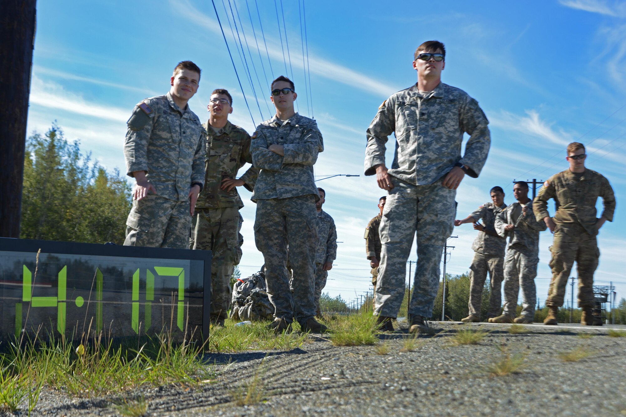 Soldiers assigned to U.S. Army Alaska observe their team members compete in the Combat Cross-Country Series 10-Mile Relay on the Davis Highway, Sept. 1, 2016. The relay consisted of five-man teams in Army Combat Uniforms and combat boots racing for the best time with 35-pound rucksacks.