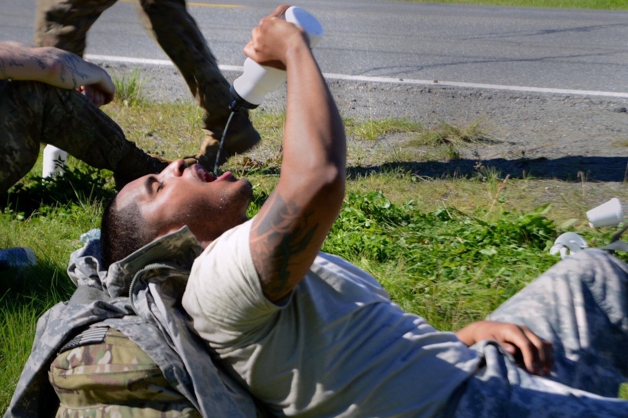 A Soldier assigned to the 98th Support Maintenance Company, 17th Combat Sustainment Support Battalion, U.S. Army Alaska, drinks water after finishing his leg of the Combat Cross-Country Series 10-Mile Relay on the Davis Highway, Sept. 1, 2016. The relay consisted of five-man teams in Army Combat Uniforms and combat boots racing for the best time with 35-pound rucksacks. 