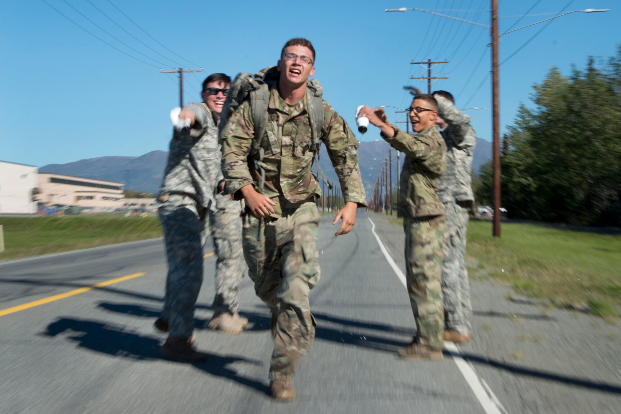 Pvt. Isaiah Collier, assigned to the 1st Battalion, 501st Parachute Infantry Regiment, 4th Infantry Brigade Combat Team (Airborne), 25th Infantry Division, U.S. Army Alaska, finishes his leg of the Combat Cross-Country Series 10-Mile Relay on the Davis Highway, Sept. 1, 2016. The relay consisted of five-man teams in Army Combat Uniforms and combat boots racing for the best time with 35-pound rucksacks.