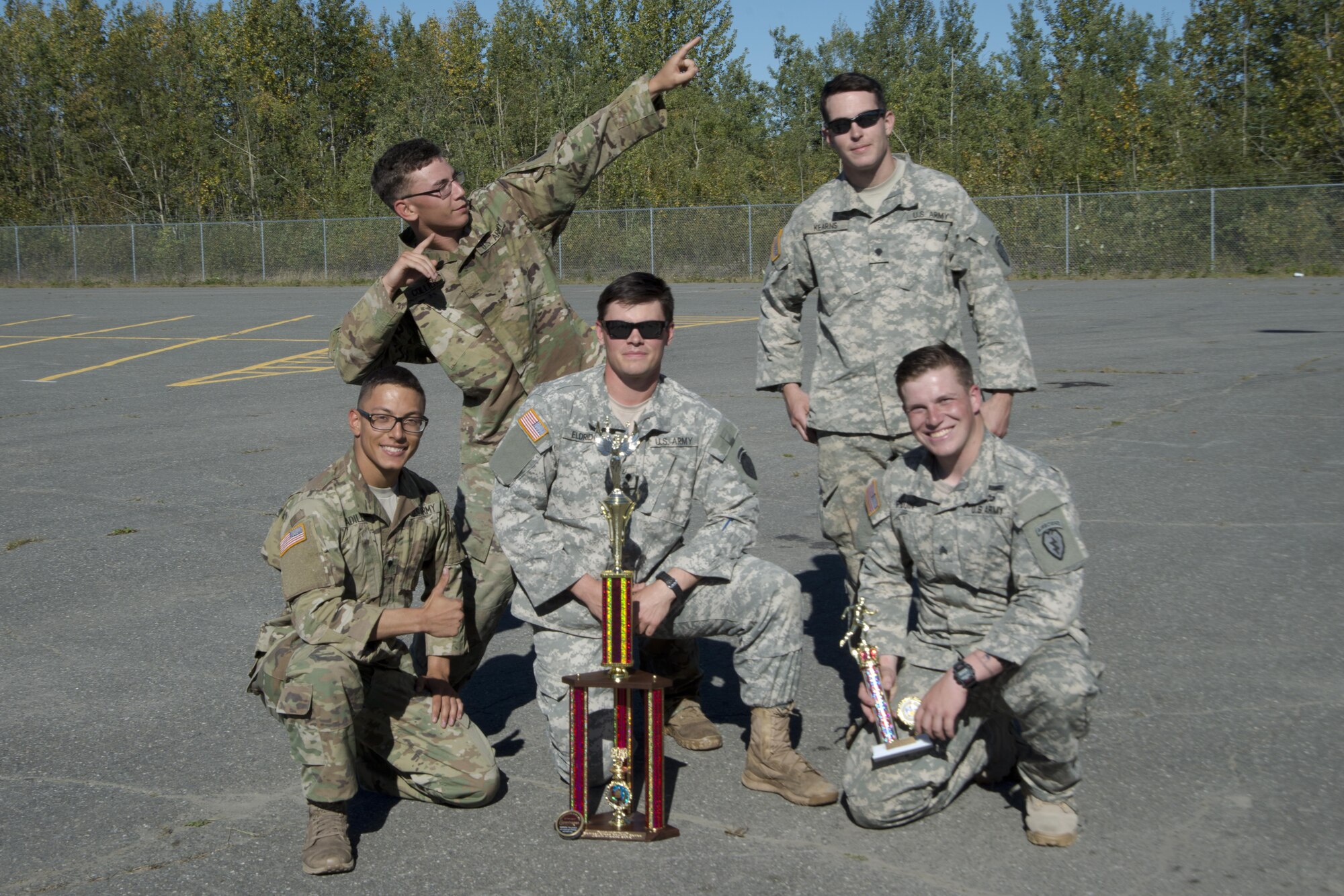 Soldiers assigned to the 1st Battalion, 501st Parachute Infantry Regiment, 4th Infantry Brigade Combat Team (Airborne), 25th Infantry Division, U.S. Army Alaska, hold their first-place trophy after finishing the Combat Cross-Country Series 10-Mile Relay on the Davis Highway, Sept. 1, 2016. The relay consisted of five-man teams in Army Combat Uniforms and combat boots racing for the best time with 35-pound rucksacks. 