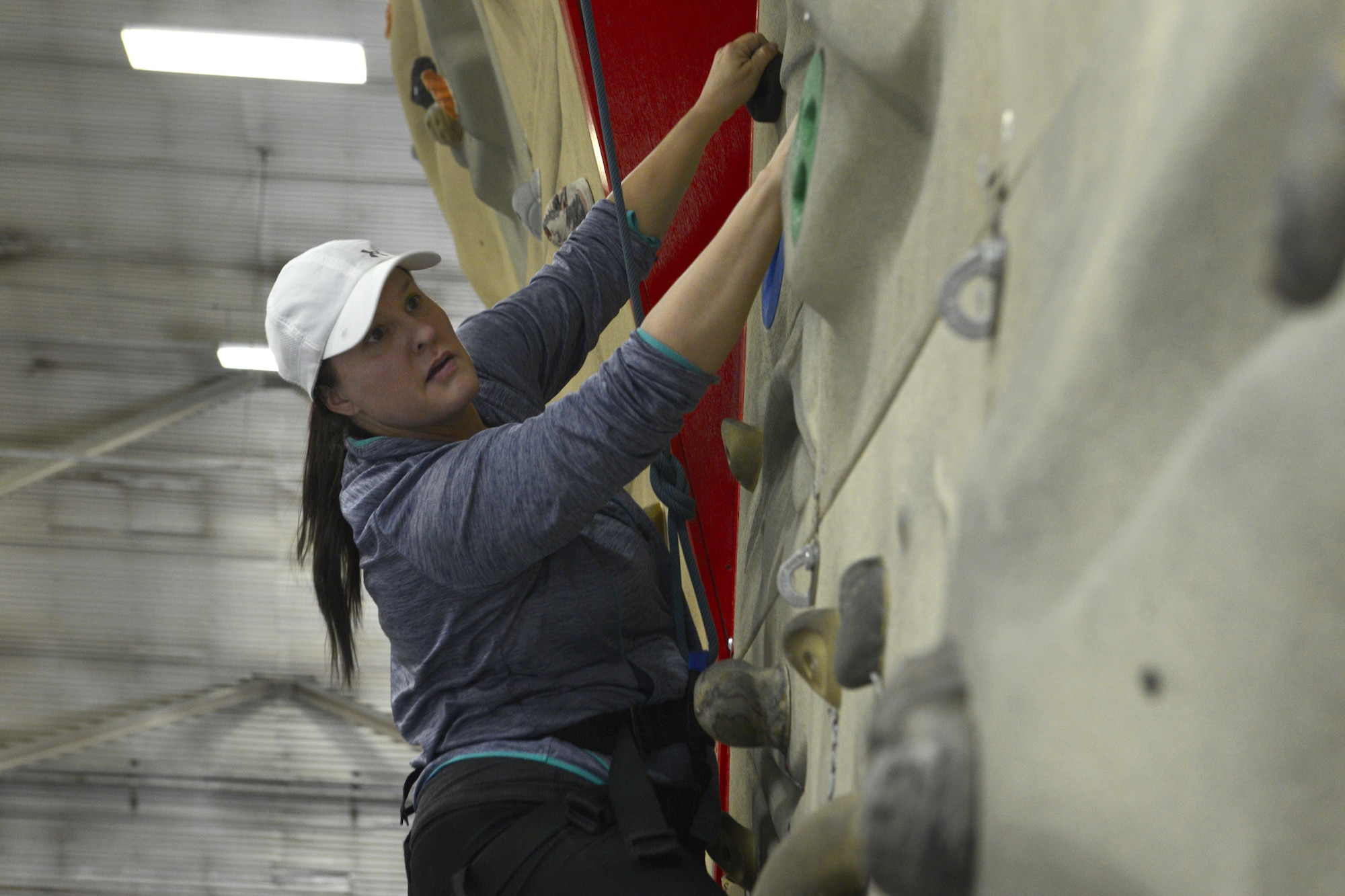 Steph Mcginty seeks out her next move on a rock wall during an introduction to climbing and belay class at the Joint Base Elmendorf-Richardson Outdoor Recreation Center, Sept. 1, 2016. The class was part of the Women in the Wilderness program which offers many introductory classes such as camping, fishing, kayaking and hiking.