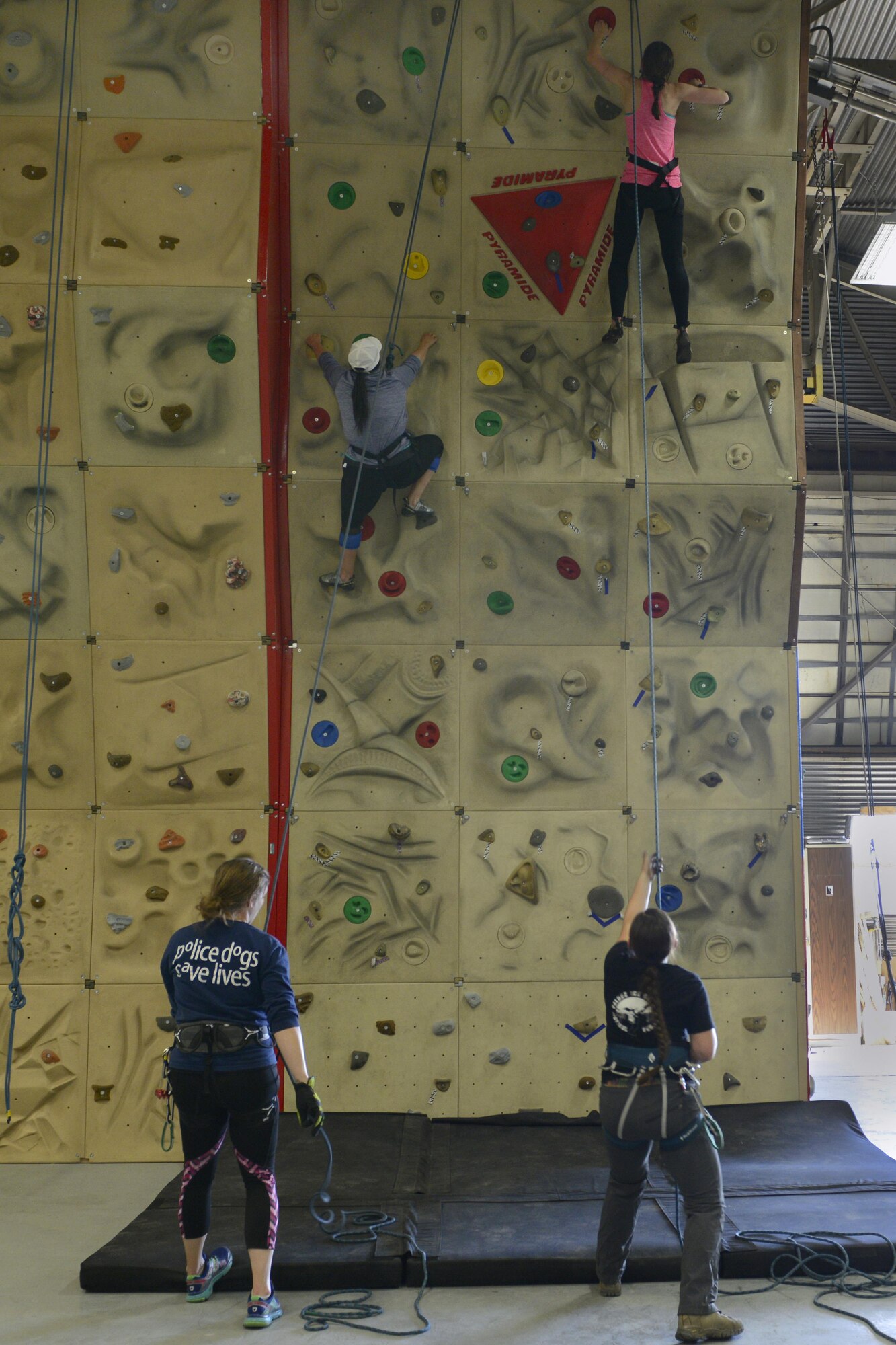 Steph Mcginty, left, and Paige Wyse, right, climb a rock wall during an introduction to climbing and belay class at the Joint Base Elmendorf-Richardson Outdoor Recreation Center, Sept. 1, 2016. The class was open to all women with base access as part of the Women in the Wilderness program. 