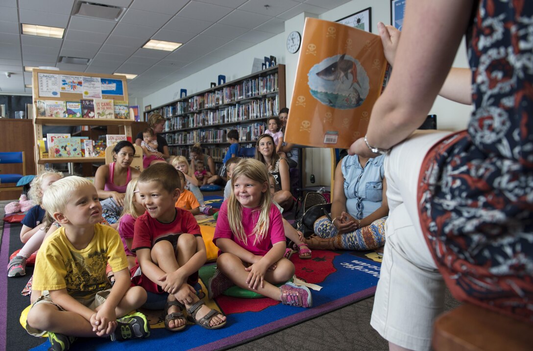 Katie Loveless, 11th Force Support Squadron senior library technician, reads “Pirates Love Underpants” to a group of children during story time at the library on Joint Base Andrews, Md., Aug. 31, 2016. Story time is held every Monday at 5:30 p.m. and every Wednesday at 10:30 a.m. (U.S. Air Force photo by Airman 1st Class Philip Bryant)