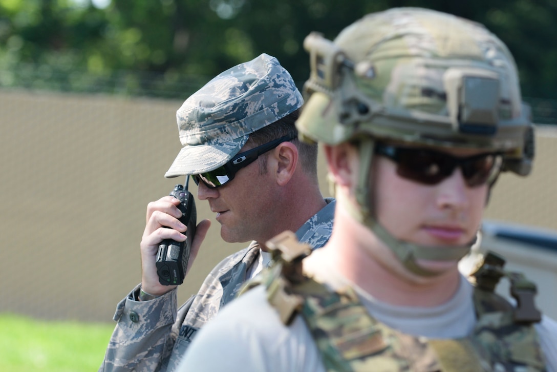 Staff Sgt. Michael Kent, 788th Civil Engineer Squadron, explosive ordinance disposal technician, radios back to the EOD control desk, the findings of Senior Airman Tyler Squibb, 788th CES, EOD technician, after he performed a recon on an unexploded ordinance during a inject of an exercise, at Wright-Patterson Air Force Base, Ohio August 2, 2016. As part of the scenario the EOD team had to identify and dispose of the explosive device in the proper manner. (U.S. Air Force photo / Wesley Farnsworth)