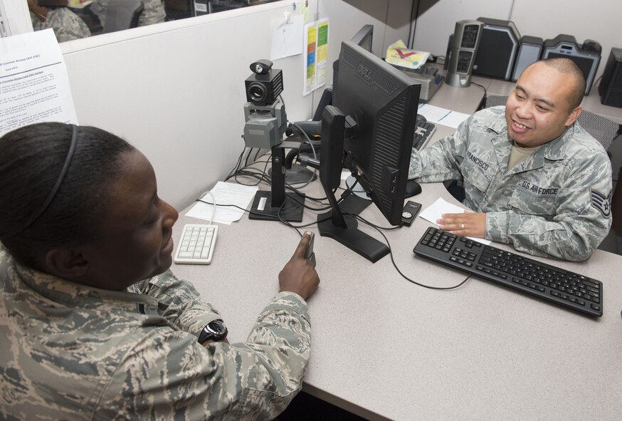 Air Force Staff Sgt. Christopher Francisco, 88th Force Support Squadron customer support technician, scans the finger print of Lt. Brittney Rufus, 88th Inpatient Operations Squadron clinical nurse, Aug. 15, 2016, at Wright-Patterson Air Force Base, Ohio.  The Defense Manpower Data Center requires fingerprint images when issuing a Common Access Card  to users. (U.S. Air Force photo / Michelle Gigante)