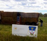 Airmen assigned to the 341st Munitions Squadron, build a payload transporter structure out of hay Sept. 6, 2016, at Judith Basin, Montana. The 341st Maintenance Group was challenged to participate in “What the Hay,” a local event where teams build structures made of bales of hay to enhance community pride. (Courtesy photo)