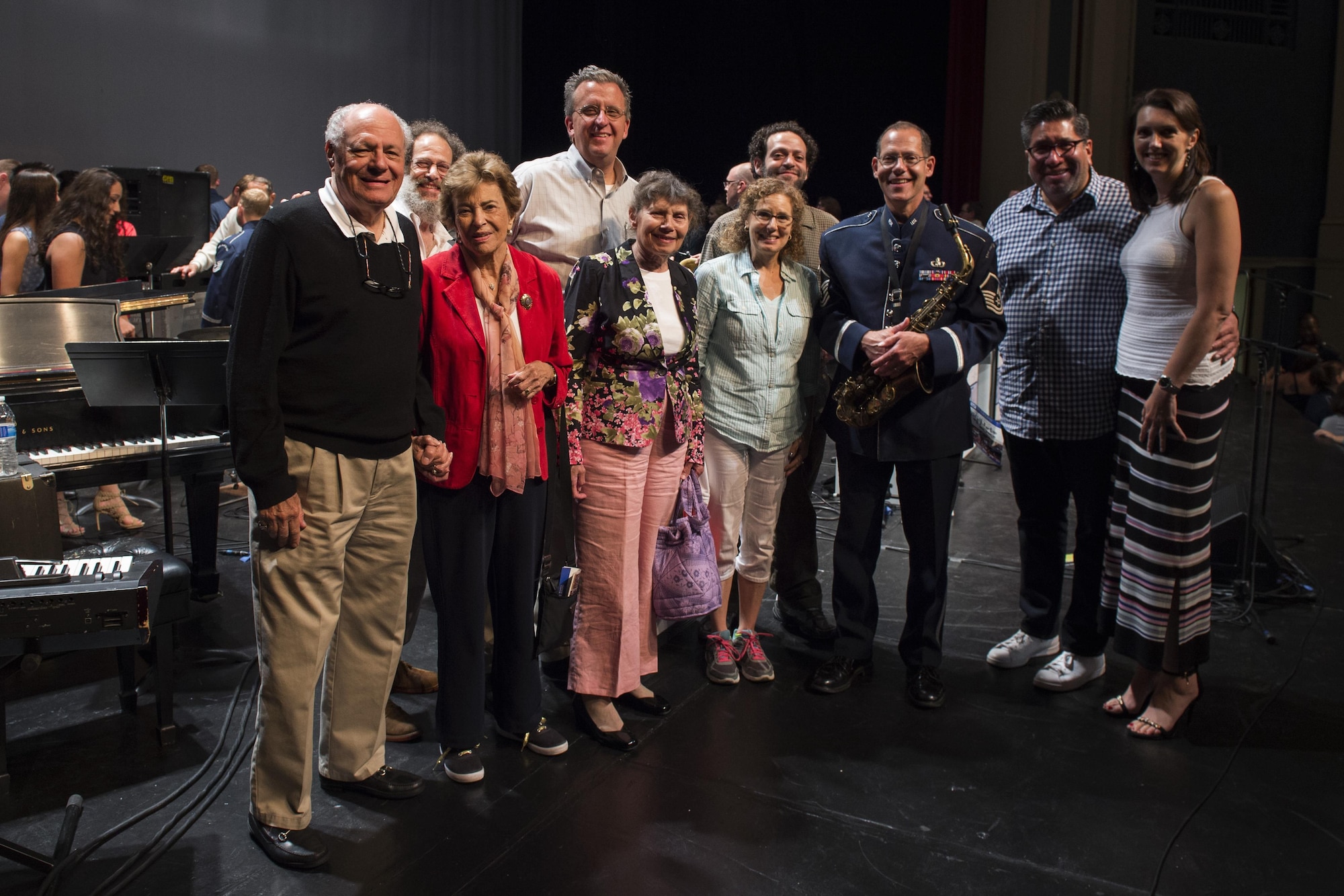 Master Sgt. Andrew Axelrad, U.S. Air Force Band’s Airmen of Note alto saxophonist, stands on stage with friends and family at North Central College’s Pfeiffer Hall in Naperville, Ill., Sept. 2, 2016. Axelrad’s family and friends had the opportunity to watch him and the Airmen of Note perform. Due to his plans to retire in February after 24 years of service, this is the last performance he will play in the Chicago area with the Airmen of Note. (U.S. Air Force photo by Senior Airman Philip Bryant)