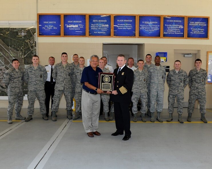 Gilbert Montoya, Director of Logistics, Engineering and Force Protection for Air Education and Training Command at Randolph Air Force Base, Texas, presents an award of accreditation to Rick Songer, 14th Civil Engineer Squadron Fire Chief, at McAllister Fire Station on Aug. 31 at Columbus Air Force Base, Mississippi. McAllister Fire Station is the second fire department in the state of Mississippi, as well as the fourth in Air Education and Training Command, to achieve this accredited status. (U.S. Air Force photo/Elizabeth Owens)