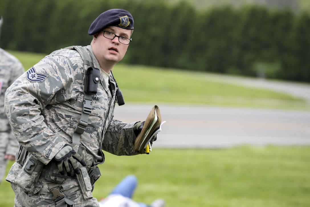 Staff Sgt. Alan Phair, 88th Security Forces Squadron installation patrolman runs between patients during mass casualty exercise at Wright-Patterson Air Force Base, May 5, 2016. The base held a week long exercise that included several different scenarios to test the preparedness of its people. (U.S. Air Force photo / Wesley Farnsworth)