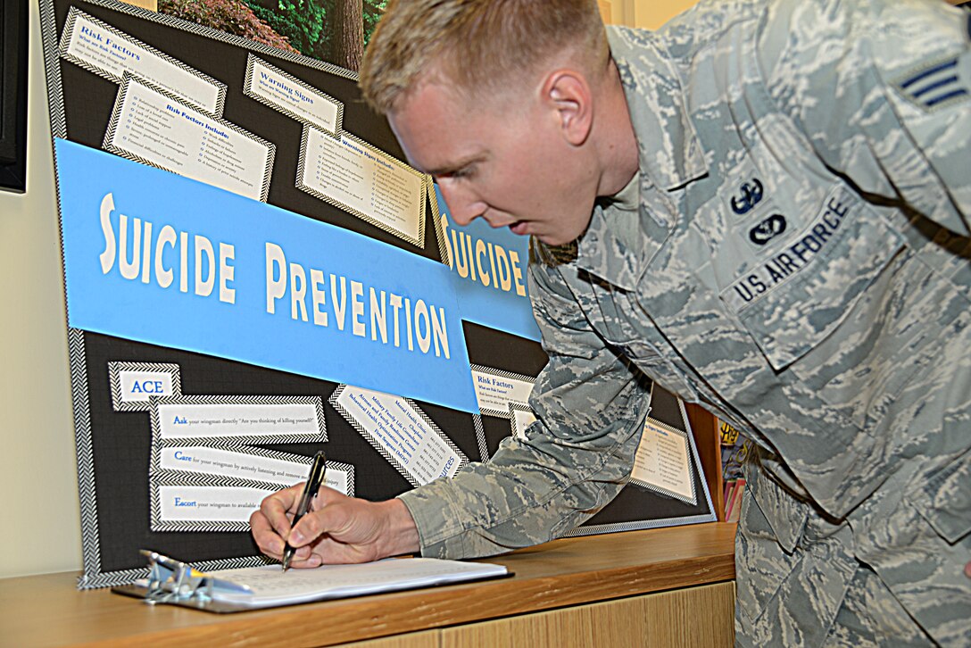 Senior Airman David Corley, 812th Civil Engineer Squadron, signs up for the 22-Push-Up Challenge. (U.S. Air Force photo by Christopher Ball)