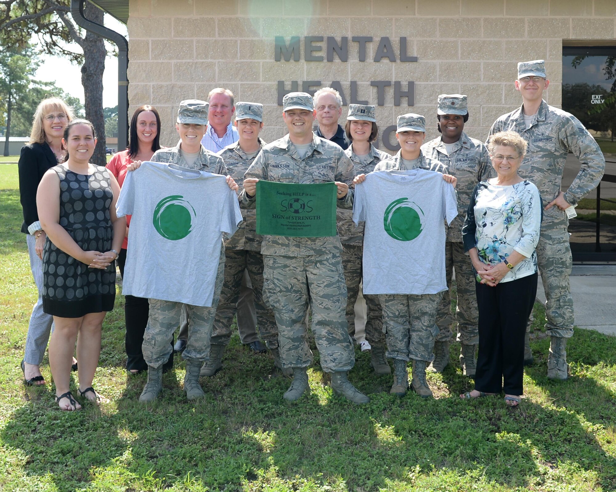 The Mental Health Flight stands in front the Mental Health Clinic at Tyndall Air Force Base, Fla., Sept. 7, 2016. The Mental Health Flight promotes both the Green Dot Program and the message of coming forward when you are suffering from mental stress or depression. (U.S. Air Force photo by Airman 1st Class Cody R. Miller/Released)
