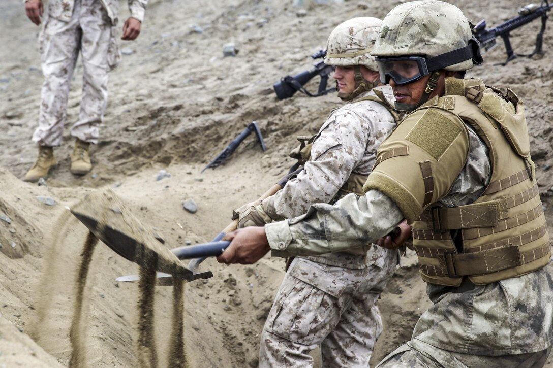 U.S. Marines and sailors work with a Peruvian marine to fill sandbags during a class on constructing fighting positions in Ancon, Peru, Sept. 3, 2016. The U.S. forces are assigned to Force Koa Moana, which is in Peru to improve interoperability with Peruvian marines. Marine Corps photo by. Sgt. Jacob Smith