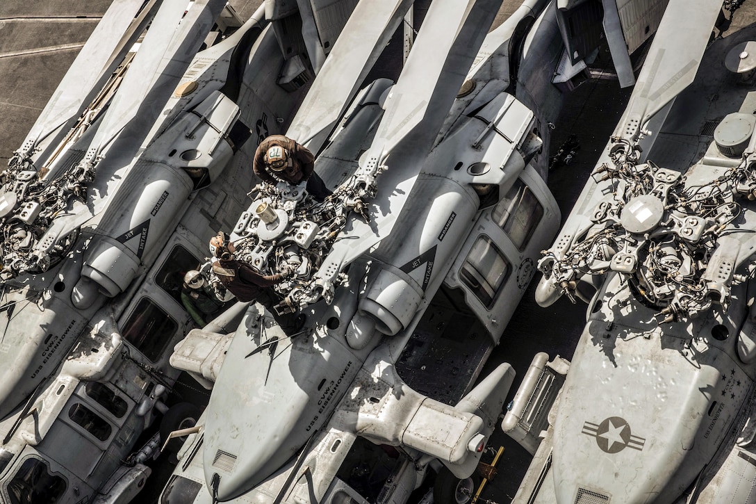 Sailors maintain the rotor of an MH-60S Seahawk helicopter on the flight deck of the aircraft carrier USS Dwight D. Eisenhower in the Persian Gulf, Sept. 7, 2016. The ship is supporting Operation Inherent Resolve, maritime security operations and theater security cooperation efforts in the U.S. 5th Fleet area of operations. The helicopter is assigned to Helicopter Sea Combat Squadron 7. Navy photo by Seaman Joshua Murray
