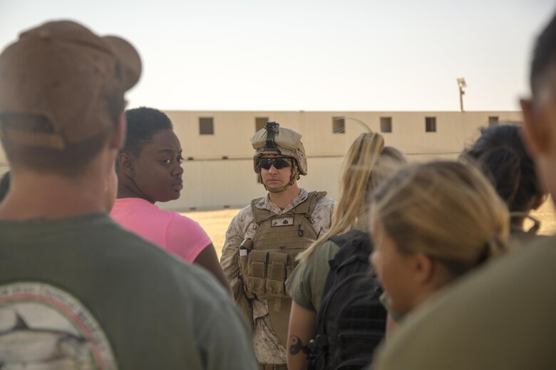 Sgt. Blake G. Sanches, embark clerk, Special Purpose Marine Air Ground Task Force, Crisis Response, Central Command, guides role-players to a notional evacuation site during a non-combatant evacuation operation exercise at Range 220, a military operations on urbanized terrain facility, aboard the Marine Corps Air Ground Combat Center, Twentynine Palms, Calif., Aug. 24, 2016, as part of a Certification Exercise. (Official Marine Corps photo by Lance Cpl. Levi Schultz/Released)