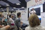 Rear Adm. John W. Korka, commander, Naval Facilities Engineering Command Pacific, demonstrates a compressed plastic disc created by shipboard waste processors during a U.S. Department of Defense conservation panel during the International Union for Conservation of Nature (IUCN) World Conservation Congress at the Hawaiian Convention Center in Honolulu, Sept. 5, 2016. IUCN is a membership Union uniquely composed of both government and civil society organizations. It provides public, private and non-governmental organizations with the knowledge and tools that enable human progress, economic development and nature conservation to take place together. 
