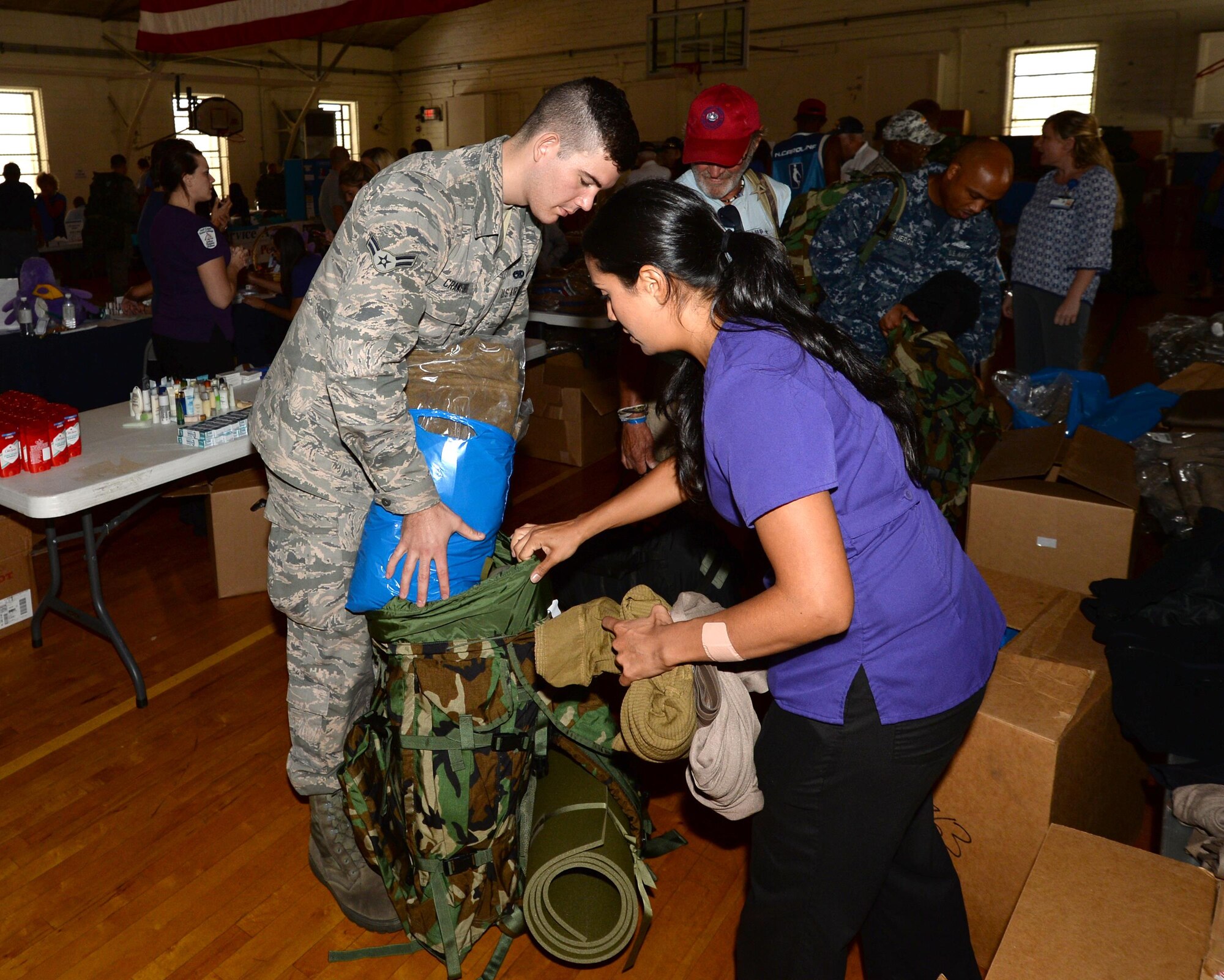 Volunteers at the “Stand Down” event pack supplies to be given to veterans in need Sept. 24, 2015 at First Baptist Family Life Center, Panama City, Fla. Service members from all branches of the military escorted and assisted veterans fill up duffel bags of much needed supplies. Members of Team Tyndall donated supplies such as towels and hygiene items to the event. (U.S. Air Force photo by Airman 1st Class Cody Miller/Released) 