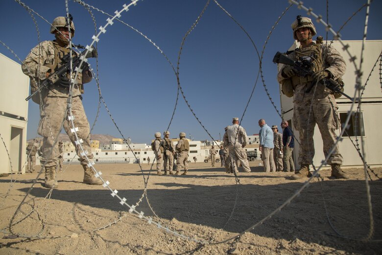Marines with Special Purpose Marine Air Ground Task Force, Crisis Response, Central Command, stand guard during a non-combatant evacuation operation exercise at Range 220, a military operations on urbanized terrain facility, aboard the Marine Corps Air Ground Combat Center, Twentynine Palms, Calif., Aug. 24, 2016. (Official Marine Corps photo by Lance Cpl. Levi Schultz/Released)