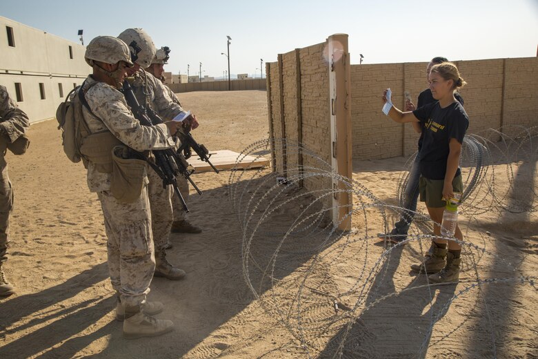 Marines with Special Purpose Marine Air Ground Task Force, Crisis Response, Central Command, interact with role-players during a non-combatant evacuation operation exercise at Range 220, a military operations on urbanized terrain facility, aboard the Marine Corps Air Ground Combat Center, Twentynine Palms, Calif., Aug. 24, 2016. (Official Marine Corps photo by Lance Cpl. Levi Schultz/Released)