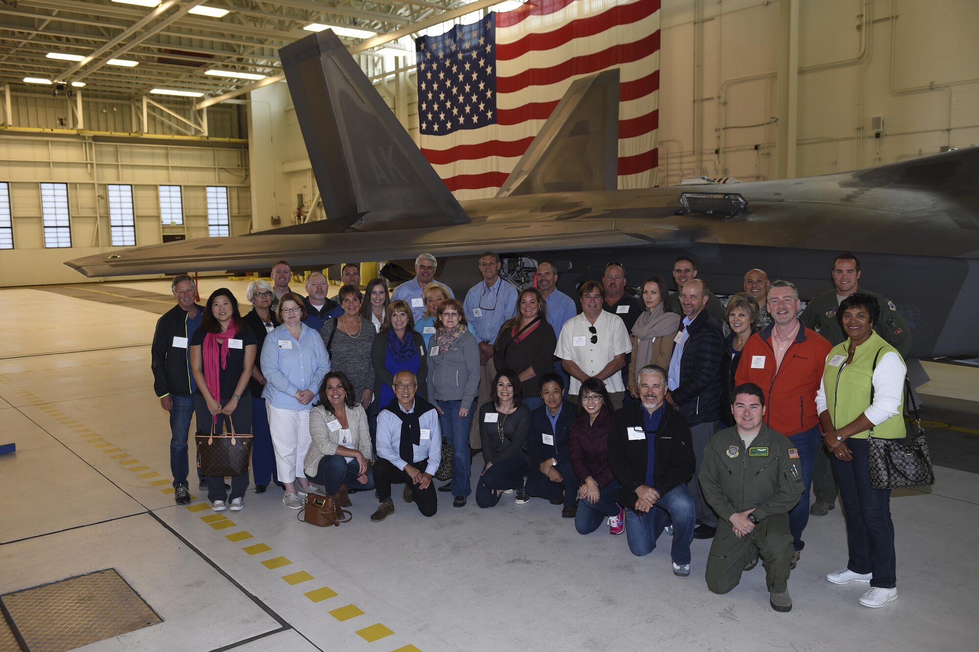 McChord civic leaders stand in front of an F-22 at Joint Base Elmendorf-Richardson, Alaska, Aug. 31, 2016. The group learned about the F-22 mission first hand, from the men and women who fly it. (U.S. Air Force photo/ Staff Sgt. Naomi Shipley)