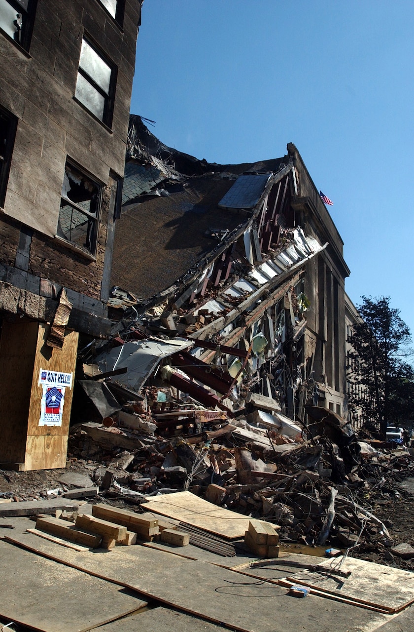 Cleanup and recovery efforts are in progress as a portion of the Pentagon lies in ruins, Sept. 12, 2001, following the 9/11 terrorist attack in which a hijacked commercial airliner was crashed into the Pentagon. Navy photo by Petty Officer 1st Class Michael W. Pendergrass.