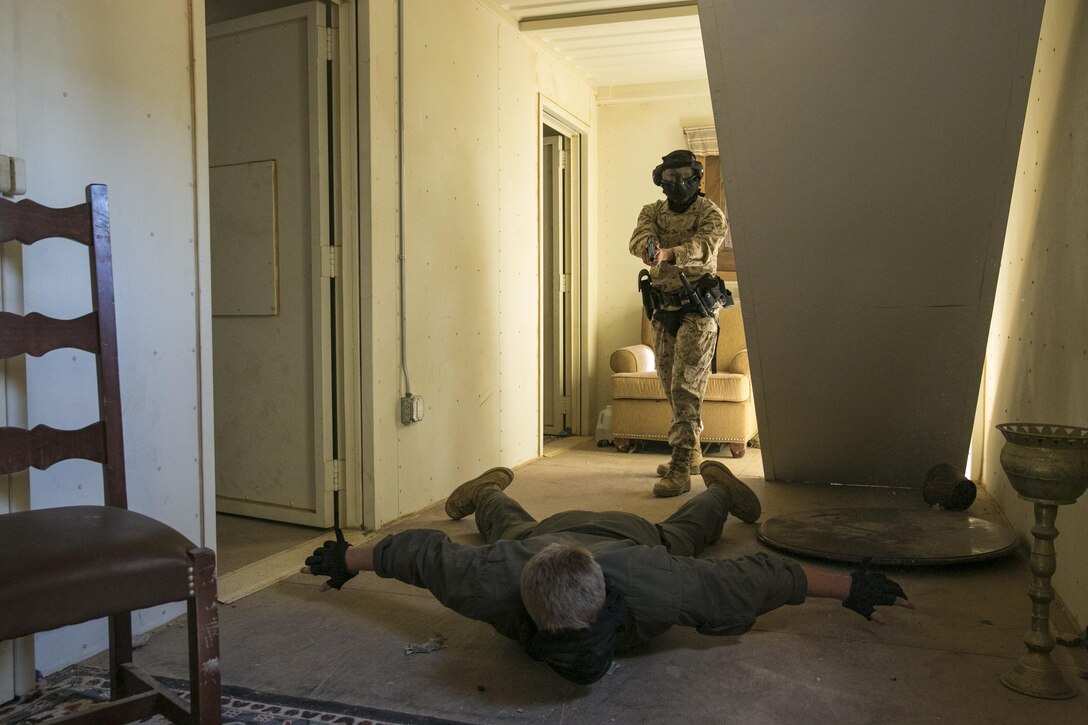 Lance Cpl. Bernice Hernandez, military police officer, Provost Marshal’s Office commands a roleplayer during a domestic disturbance simulation at Range 800 aboard Marine Corps Air Ground Combat Center, Twentynine Palms, Calif., Aug. 30, 2016. PMO uses these drills to prepare for scenarios they could potentially encounter while out on patrol. (Official Marine Corps photo by Lance Cpl. Dave Flores/Released)