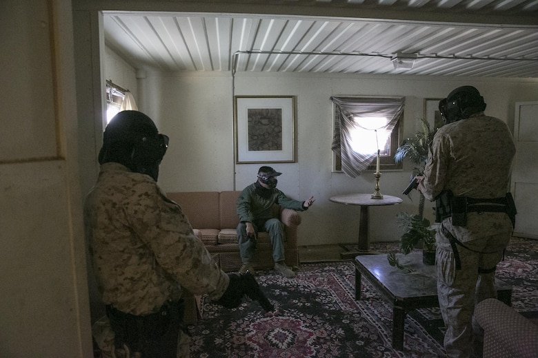 Cpl. Brenten Olson and Lance Cpl. Jeff Hernandez, military police officers, Provost Marshal’s Office, converse with a roleplayer during a domestic disturbance exercise at Range 800 aboard Marine Corps Air Ground Combat Center, Twentynine Palms, Calif., Aug. 30, 2016. PMO uses these drills to prepare for scenarios they could potentially encounter while out on patrol. (Official Marine Corps photo by Lance Cpl. Dave Flores/Released)
