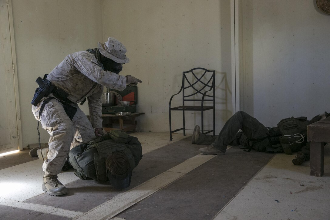 Sgt. Timothy Hodapp, military police officer, Provost Marshal’s Office, detains role players during an escalation of force exercise at Range 800 aboard Marine Corps Air Ground Combat Center, Twentynine Palms, Calif., Aug. 30, 2016. PMO uses these drills to prepare for scenarios they could potentially encounter while out on patrol. (Official Marine Corps photo by Lance Cpl. Dave Flores/Released)