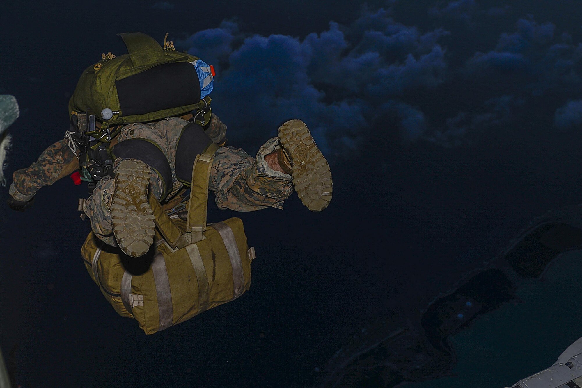 A III Marine Expeditionary Force, 31st Marine Expeditionary Unit, Force Reconnaissance Platoon member, jumps from an MC-130J Commando II from the 17th Special Operations Squadron during an airfield seizure exercise Aug. 24, at Wake Island. Both the Airmen and Marines were able to take a lot away from the training and discover what they can do better together in the future. (U.S. Air Force photo by Senior Airmen Stephen G. Eigel)

